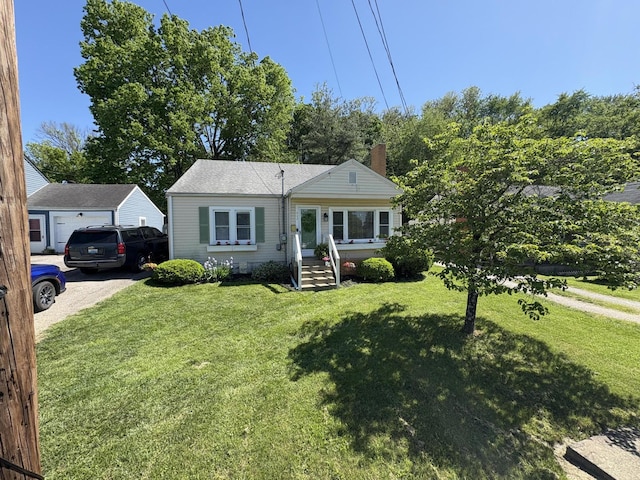 view of front of home featuring a front lawn, a garage, and a chimney