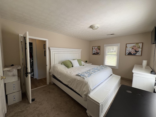 bedroom featuring carpet floors and a textured ceiling
