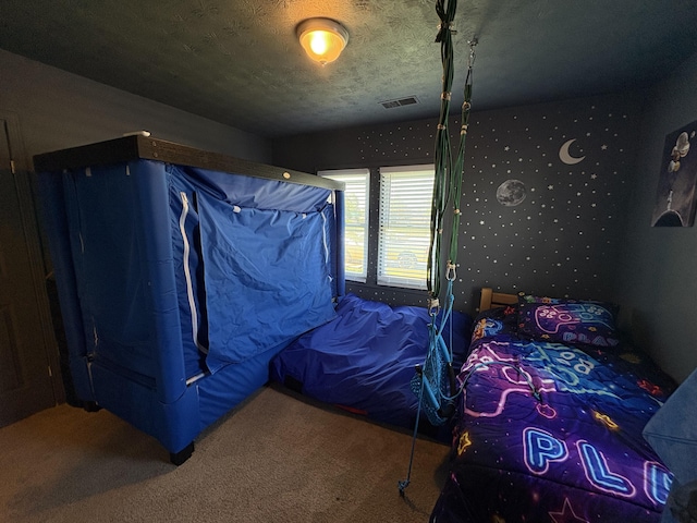 carpeted bedroom featuring a textured ceiling