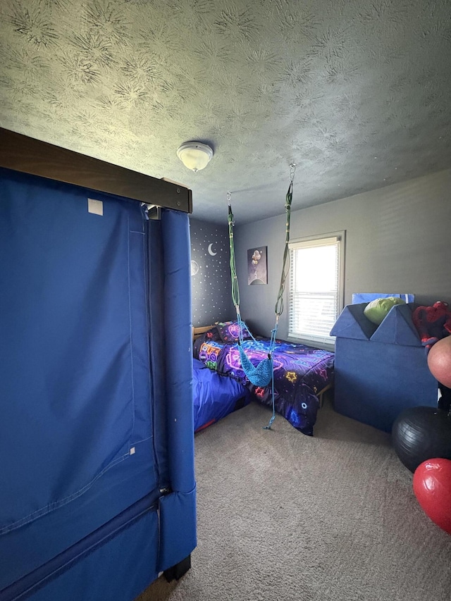 bedroom with carpet and a textured ceiling