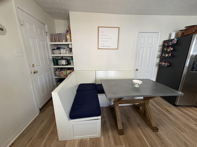 dining area with wood finished floors