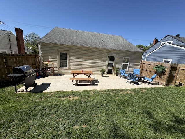 back of house featuring a patio and roof with shingles