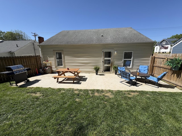back of property featuring a patio area and roof with shingles