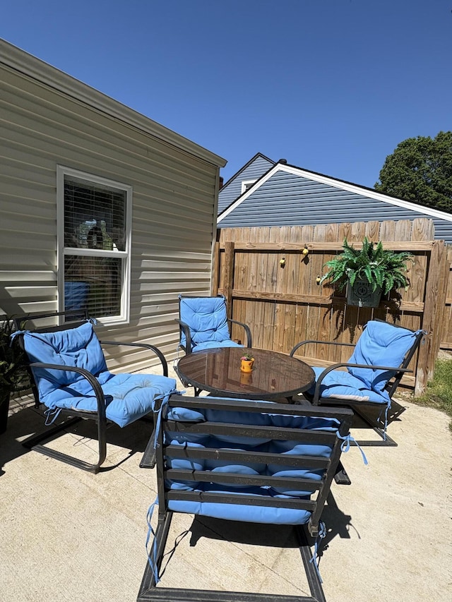 view of patio featuring fence and outdoor dining space