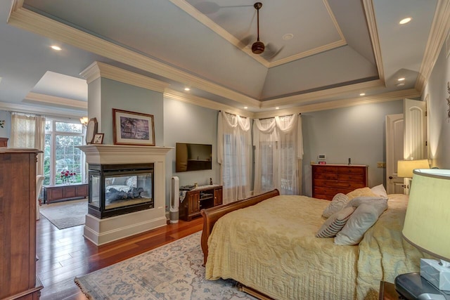 150 Old Woods Dr, Nicholasville, KY 40356 - bedroom featuring a tray ceiling, crown molding, wood finished floors, and a multi sided fireplace