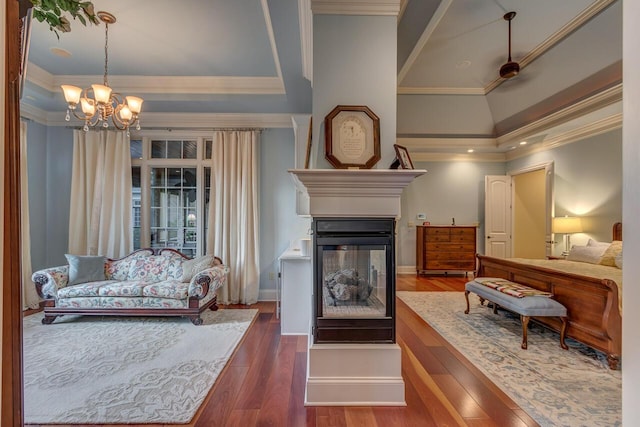 150 Old Woods Dr, Nicholasville, KY 40356 - bedroom with a multi sided fireplace, a chandelier, wood finished floors, crown molding, and baseboards
