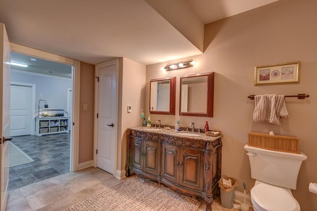 150 Old Woods Dr, Nicholasville, KY 40356 - bathroom featuring double vanity, baseboards, and toilet