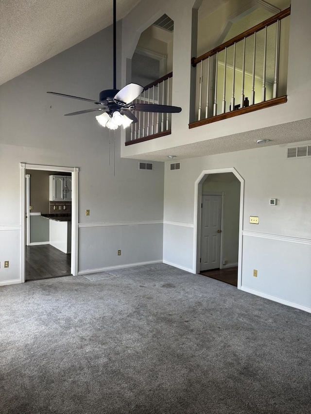 400 Natures Pointe Dr, Somerset, KY 42503 - unfurnished living room featuring high vaulted ceiling, carpet flooring, a ceiling fan, arched walkways, and a textured ceiling