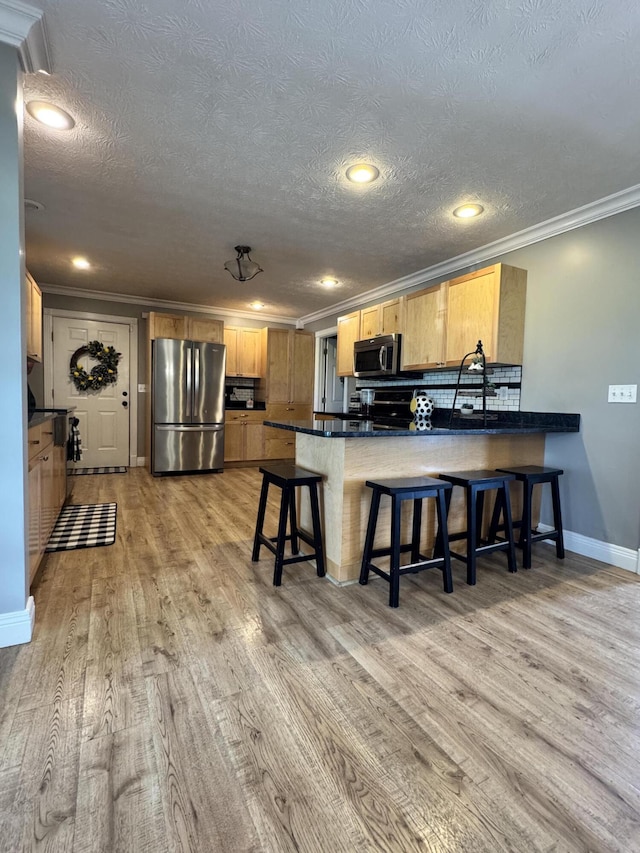 2230 Perryville Rd, Harrodsburg, KY 40330 - kitchen with stainless steel appliances, a peninsula, ornamental molding, light wood-type flooring, and baseboards