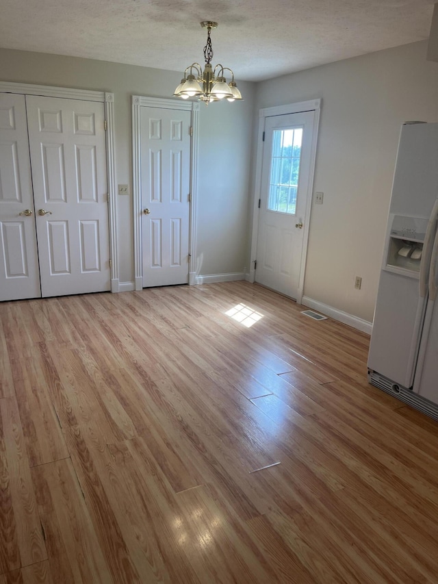 361 Puncheon Camp Rd, Russell Springs, KY 42642 - unfurnished dining area with a chandelier, light wood finished floors, and baseboards