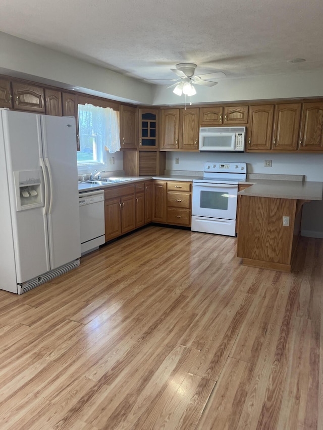 361 Puncheon Camp Rd, Russell Springs, KY 42642 - kitchen featuring white appliances, brown cabinets, and light wood-style floors