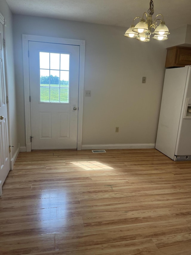 361 Puncheon Camp Rd, Russell Springs, KY 42642 - doorway to outside featuring a chandelier, light wood-style flooring, and baseboards