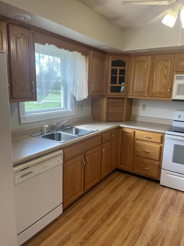 361 Puncheon Camp Rd, Russell Springs, KY 42642 - kitchen featuring white appliances, a sink, light countertops, brown cabinetry, and light wood-style floors