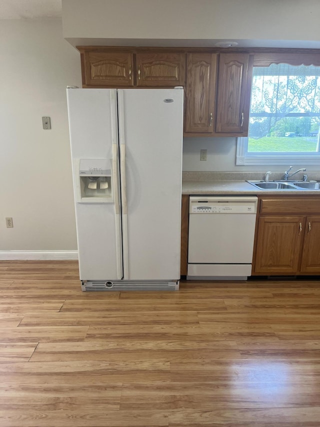 361 Puncheon Camp Rd, Russell Springs, KY 42642 - kitchen with white appliances, a sink, light wood-type flooring, and light countertops