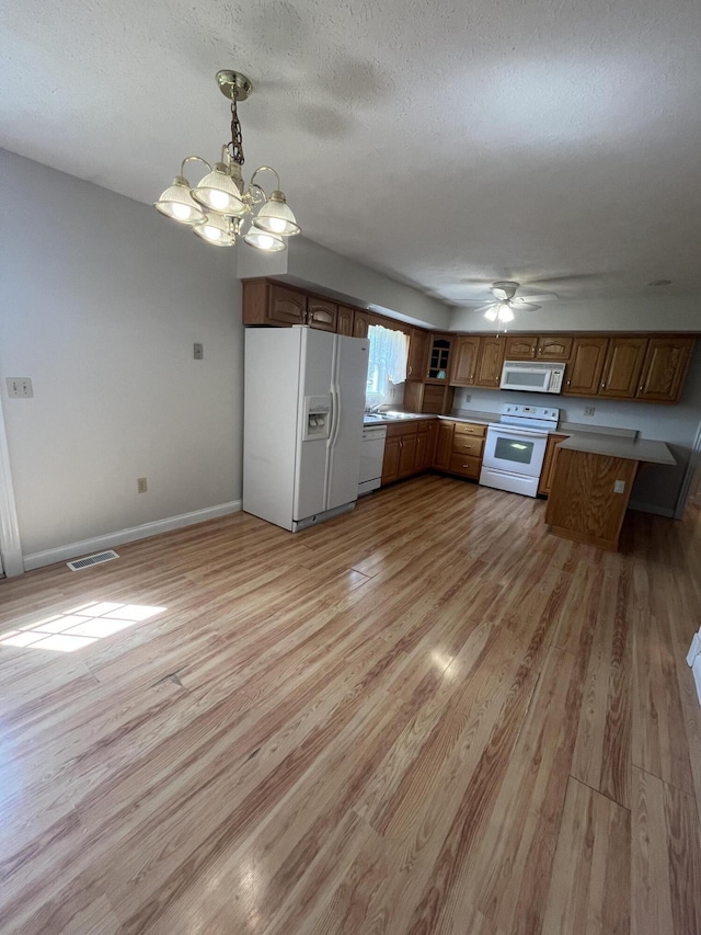 361 Puncheon Camp Rd, Russell Springs, KY 42642 - kitchen featuring white appliances, brown cabinetry, light wood-style flooring, a chandelier, and a ceiling fan