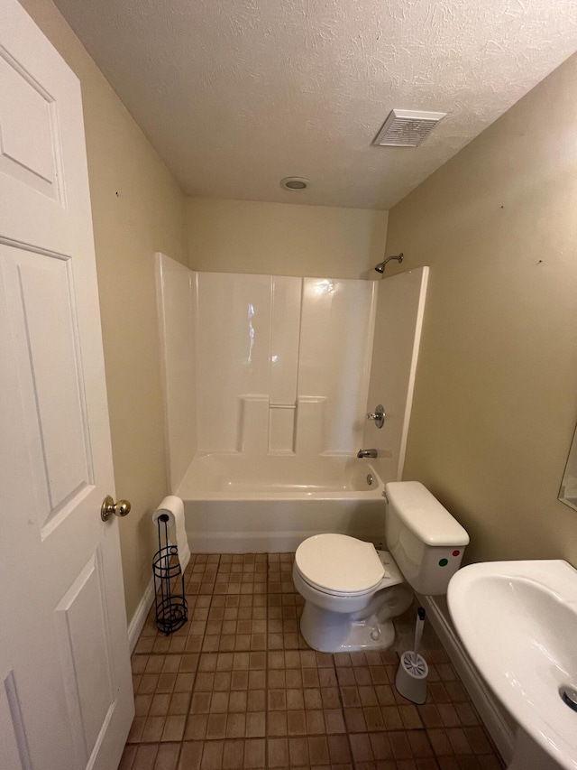 361 Puncheon Camp Rd, Russell Springs, KY 42642 - bathroom with a textured ceiling, toilet, tub / shower combination, a sink, and baseboards