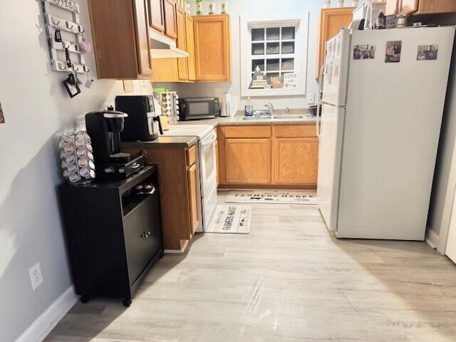 27 Bait Shop Rd, Salt Lick, KY 40371 - kitchen with white appliances, a sink, light wood finished floors, light countertops, and ventilation hood