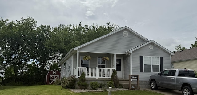 196 Harrods Trce, Harrodsburg, KY 40330 - view of front of home with a porch, a front lawn, an outdoor structure, and a shed