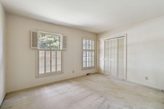 unfurnished bedroom featuring a closet, carpet floors, and baseboards
