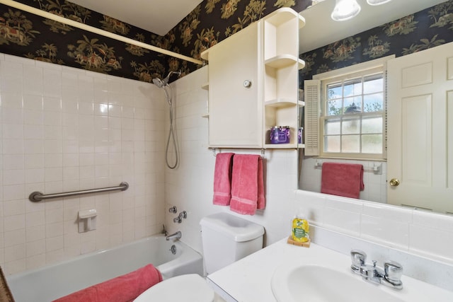 bathroom with wallpapered walls, shower / bathtub combination, toilet, and vanity