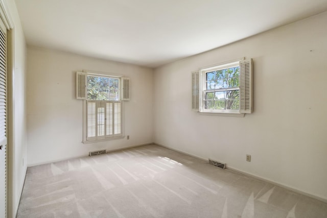 carpeted empty room with baseboards