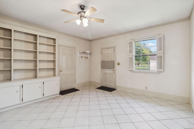 spare room with ornamental molding, ceiling fan, baseboards, and light tile patterned floors