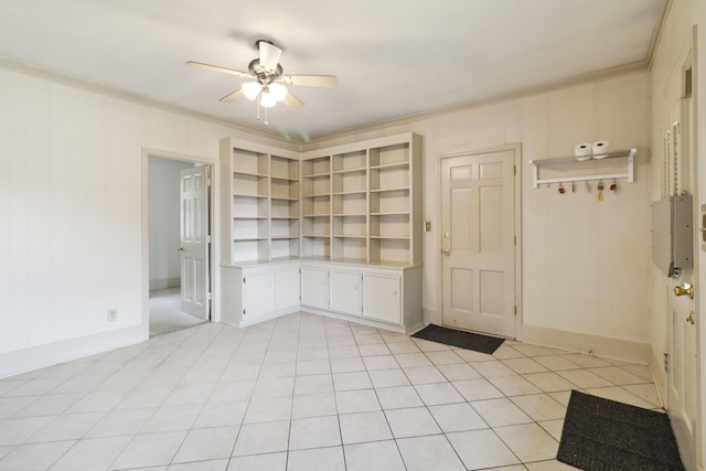 empty room with a ceiling fan, ornamental molding, and baseboards