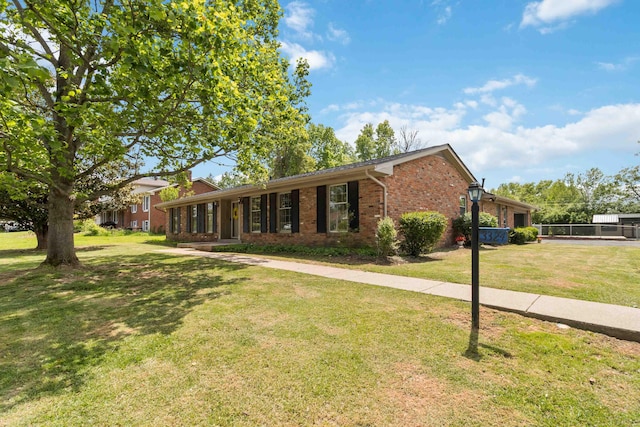 view of front of home with brick siding and a front yard