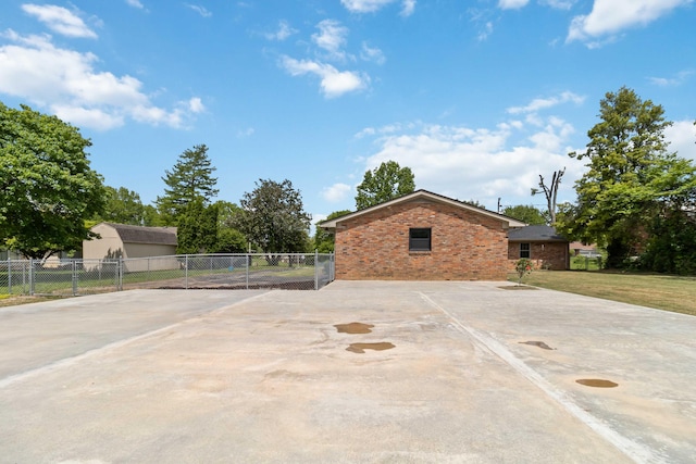 view of patio / terrace featuring fence and driveway