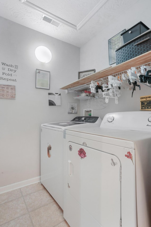 3065 Caddis Ln, Lexington, KY 40511 - clothes washing area featuring separate washer and dryer, baseboards, light tile patterned floors, and a textured ceiling