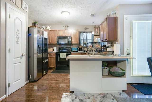 3065 Caddis Ln, Lexington, KY 40511 - kitchen with black appliances, a peninsula, dark wood-type flooring, and brown cabinetry