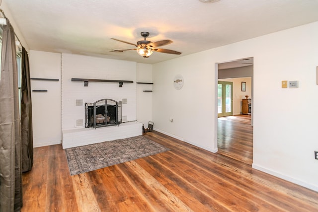 1102 Iroquois Dr, Mt Sterling, KY 40353 - unfurnished living room featuring wood finished floors, a ceiling fan, a brick fireplace, and baseboards