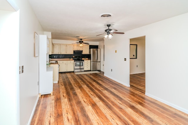 1102 Iroquois Dr, Mt Sterling, KY 40353 - kitchen featuring appliances with stainless steel finishes, hardwood / wood-style flooring, decorative backsplash, ceiling fan, and baseboards