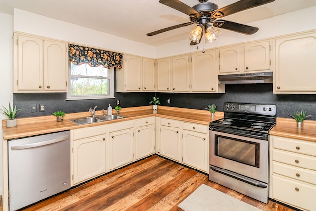 1102 Iroquois Dr, Mt Sterling, KY 40353 - kitchen with stainless steel appliances, a sink, under cabinet range hood, wood finished floors, and cream cabinets