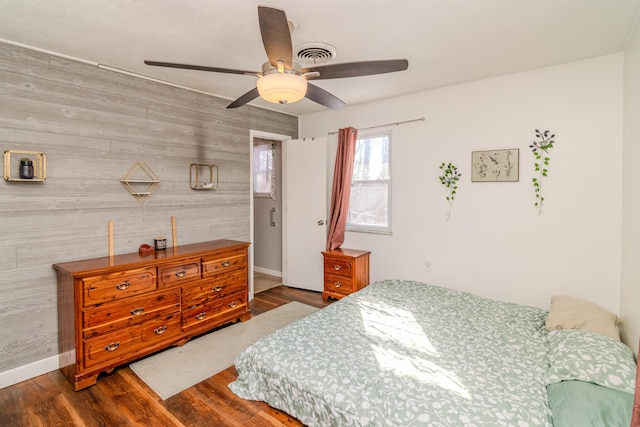 1102 Iroquois Dr, Mt Sterling, KY 40353 - bedroom featuring wood finished floors, baseboards, wooden walls, an accent wall, and a ceiling fan