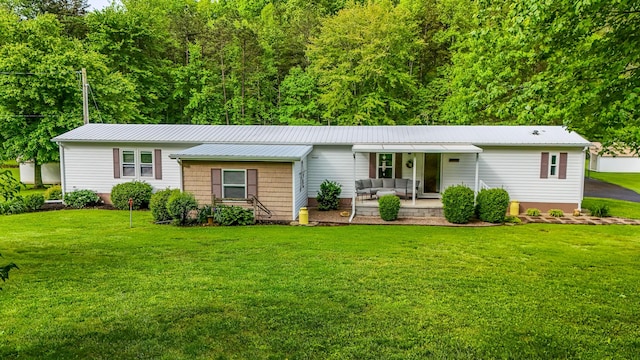 199 Langnau Rd, London, KY 40741 - ranch-style home with outdoor lounge area, a front yard, metal roof, and a patio area