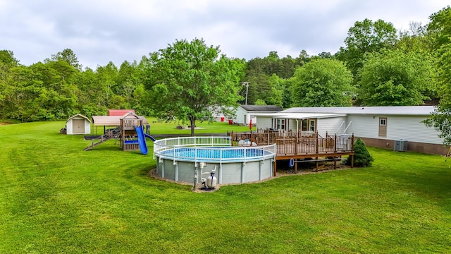 199 Langnau Rd, London, KY 40741 - swimming pool featuring a storage unit, a deck, cooling unit, and a lawn