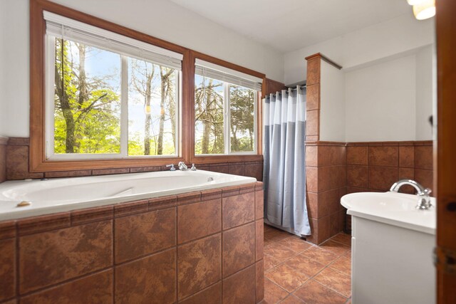 571 Whitlock Rd, Richmond, KY 40475 - full bathroom featuring a garden tub, a wainscoted wall, tile patterned flooring, curtained shower, and tile walls