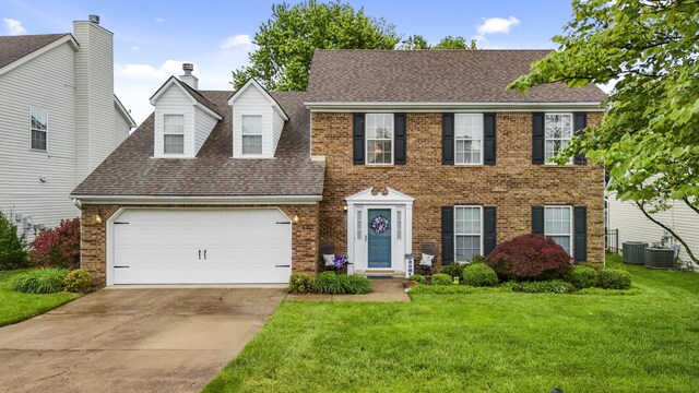 view of front of house with a front lawn, driveway, a garage, and a shingled roof