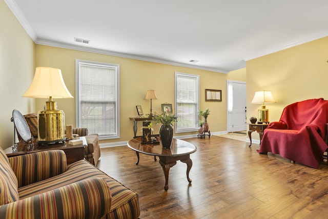 living area featuring crown molding, wood finished floors, and baseboards