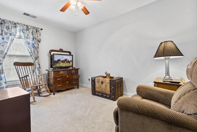 living area featuring ceiling fan, carpet, and baseboards