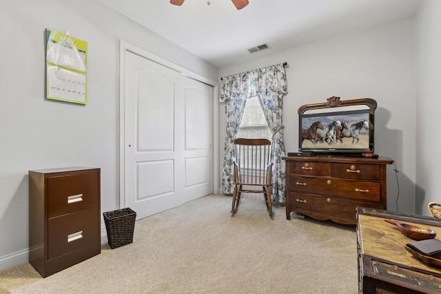 living area featuring carpet flooring, a ceiling fan, and baseboards