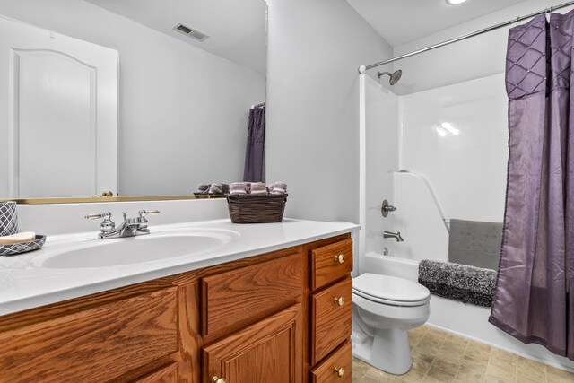 bathroom featuring vanity, toilet, and shower / bath combo with shower curtain