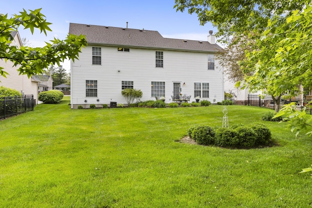 back of house with a chimney