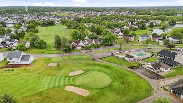 aerial view of residential area with a golf club and a nearby body of water
