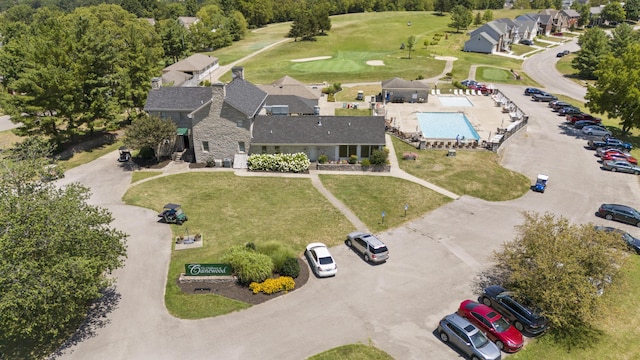 drone / aerial view of a pool and a golf club