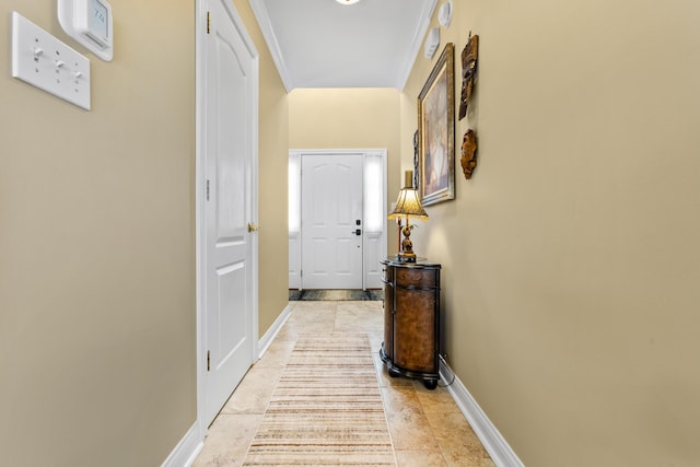 corridor with baseboards and ornamental molding