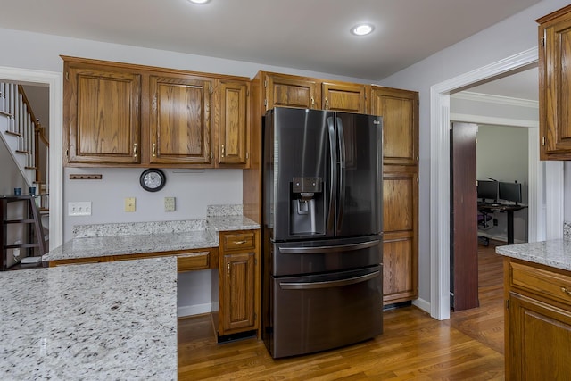 kitchen with refrigerator with ice dispenser, brown cabinetry, dark wood-type flooring, and recessed lighting