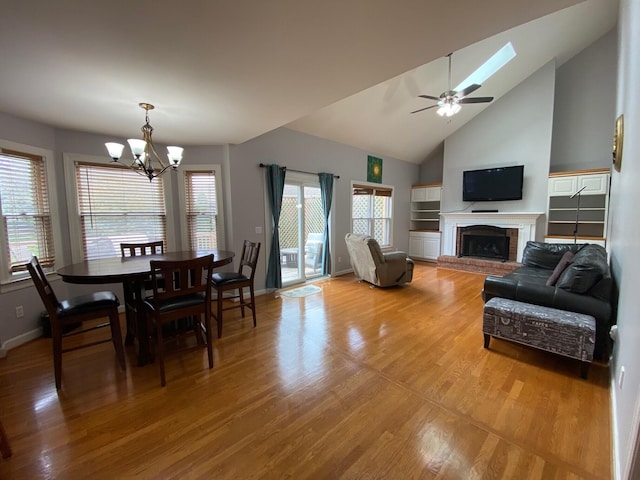 4120 Amberwood Ct, Lexington, KY 40513 - living room featuring a chandelier, plenty of natural light, light wood-style flooring, a fireplace, and vaulted ceiling