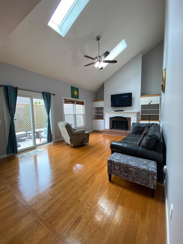 4120 Amberwood Ct, Lexington, KY 40513 - living area featuring a skylight, a ceiling fan, light wood-type flooring, a fireplace, and high vaulted ceiling